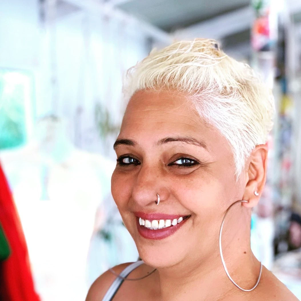 Bleach blonde cropped pixie with even short length all around