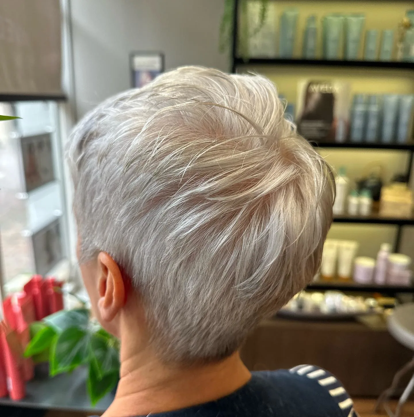 Short layered silver pixie alternate angle showing crown movement