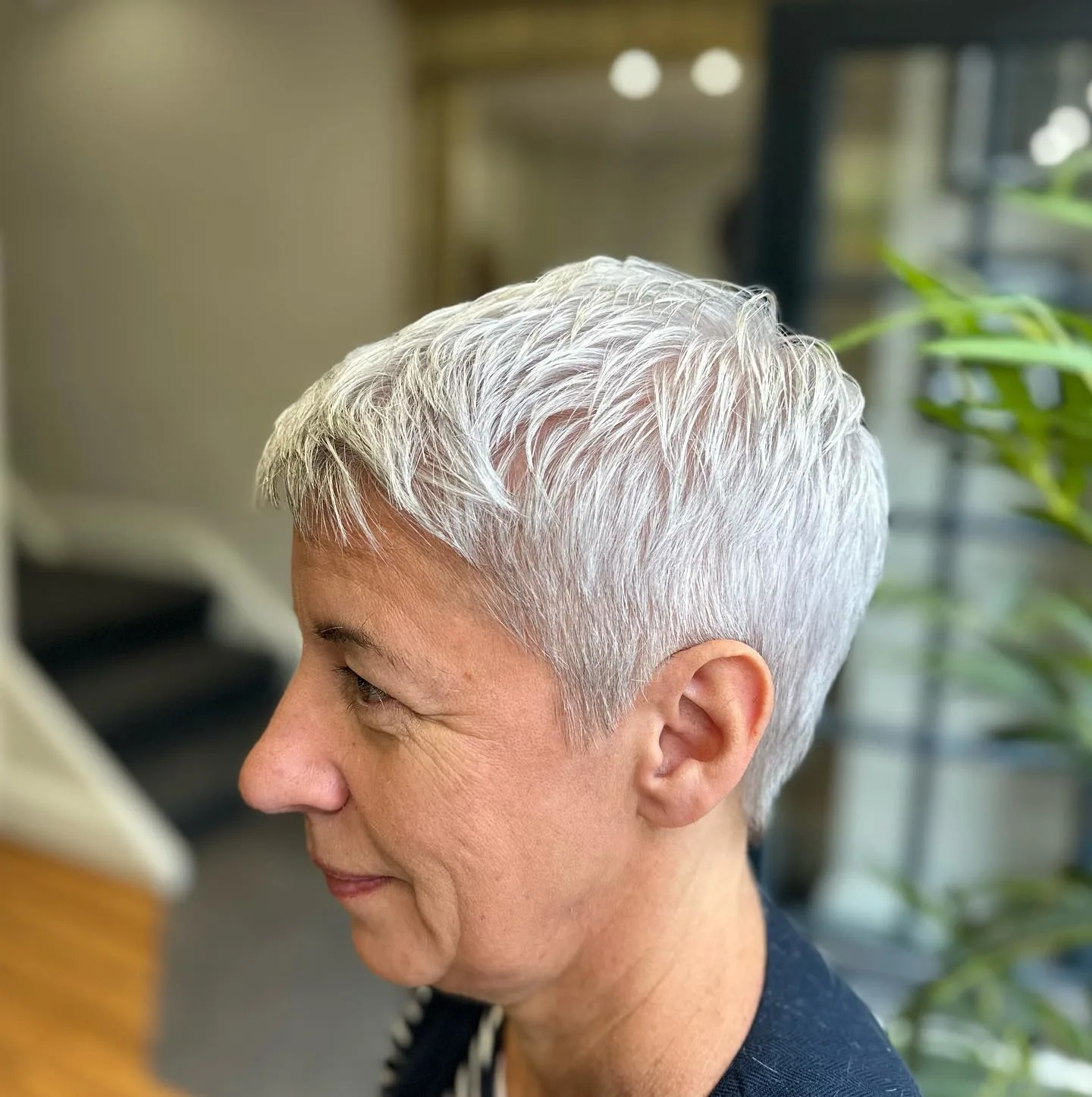 Short layered silver pixie with bright reflective finish