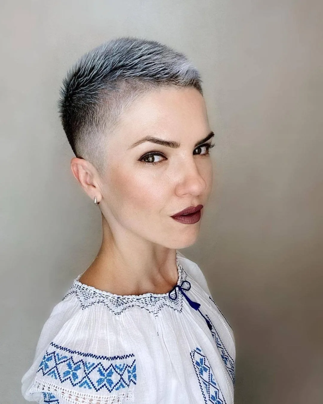 Ultra short buzzed pixie with smooth fade and silvery tone